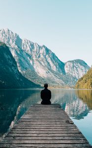 Preview wallpaper mountains, alone, lake, pier, solitude