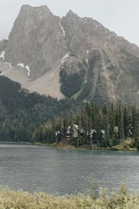 Preview wallpaper mountains, building, river, trees, spruce