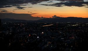 Preview wallpaper mountains, buildings, lights, city, dawn, dark