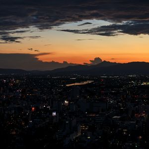 Preview wallpaper mountains, buildings, lights, city, dawn, dark