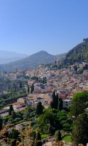 Preview wallpaper mountains, buildings, roofs, trees, city