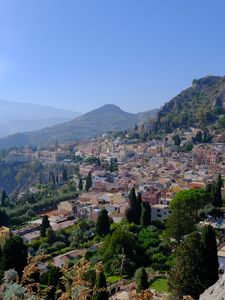 Preview wallpaper mountains, buildings, roofs, trees, city