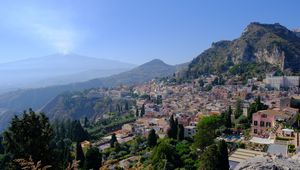 Preview wallpaper mountains, buildings, roofs, trees, city