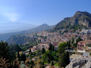 Preview wallpaper mountains, buildings, roofs, trees, city