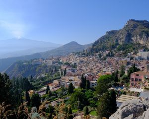 Preview wallpaper mountains, buildings, roofs, trees, city