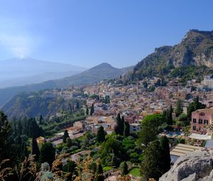 Preview wallpaper mountains, buildings, roofs, trees, city