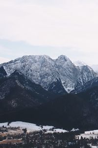 Preview wallpaper mountains, buildings, sky, peaks, snow