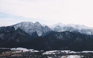 Preview wallpaper mountains, buildings, sky, peaks, snow