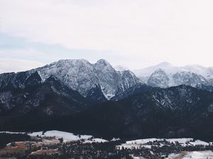 Preview wallpaper mountains, buildings, sky, peaks, snow