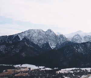 Preview wallpaper mountains, buildings, sky, peaks, snow