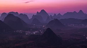 Preview wallpaper mountains, buildings, sunset, distance, sky