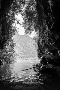 Preview wallpaper mountains, cave, river, boat, silhouettes, black and white