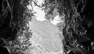 Preview wallpaper mountains, cave, river, boat, silhouettes, black and white