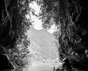 Preview wallpaper mountains, cave, river, boat, silhouettes, black and white