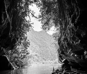 Preview wallpaper mountains, cave, river, boat, silhouettes, black and white