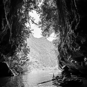 Preview wallpaper mountains, cave, river, boat, silhouettes, black and white