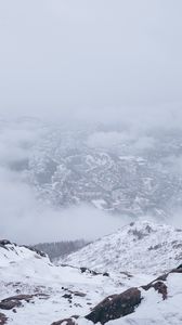 Preview wallpaper mountains, city, aerial view, fog, snow, clouds