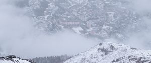 Preview wallpaper mountains, city, aerial view, fog, snow, clouds