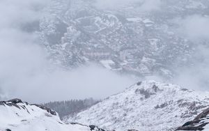 Preview wallpaper mountains, city, aerial view, fog, snow, clouds