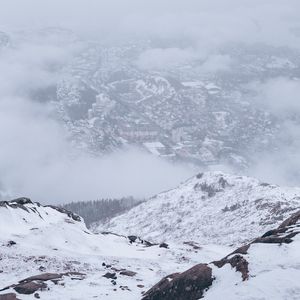 Preview wallpaper mountains, city, aerial view, fog, snow, clouds