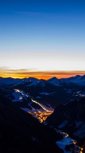 Preview wallpaper mountains, city, aerial view, valley, lights, night