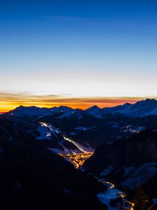 Preview wallpaper mountains, city, aerial view, valley, lights, night