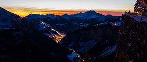 Preview wallpaper mountains, city, aerial view, valley, lights, night