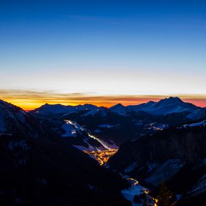 Preview wallpaper mountains, city, aerial view, valley, lights, night