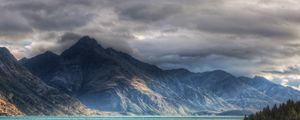 Preview wallpaper mountains, clouds, cloudy, rocks, water, multi-colored, lake