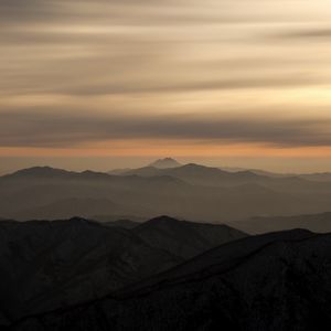 Preview wallpaper mountains, fog, sky, sunset, distance