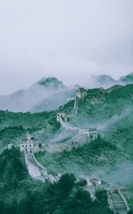 Preview wallpaper mountains, fog, wall, building, aerial view