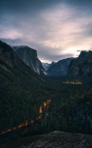 Preview wallpaper mountains, forest, road, glow, aerial view