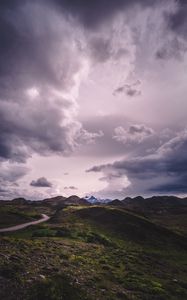 Preview wallpaper mountains, grass, clouds, overcast, twilight, cloudy