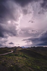 Preview wallpaper mountains, grass, clouds, overcast, twilight, cloudy