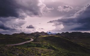 Preview wallpaper mountains, grass, clouds, overcast, twilight, cloudy