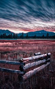 Preview wallpaper mountains, grass, fence, trees, sky, evening