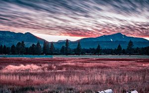 Preview wallpaper mountains, grass, fence, trees, sky, evening