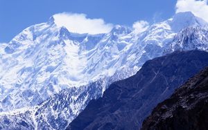 Preview wallpaper mountains, greatness, wall, snow, tops, shadow, clouds, sky