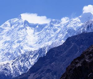 Preview wallpaper mountains, greatness, wall, snow, tops, shadow, clouds, sky