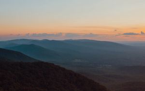 Preview wallpaper mountains, hills, aerial view, fog, dusk