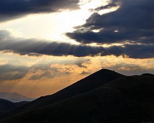Preview wallpaper mountains, hills, clouds, rays, sun, dark