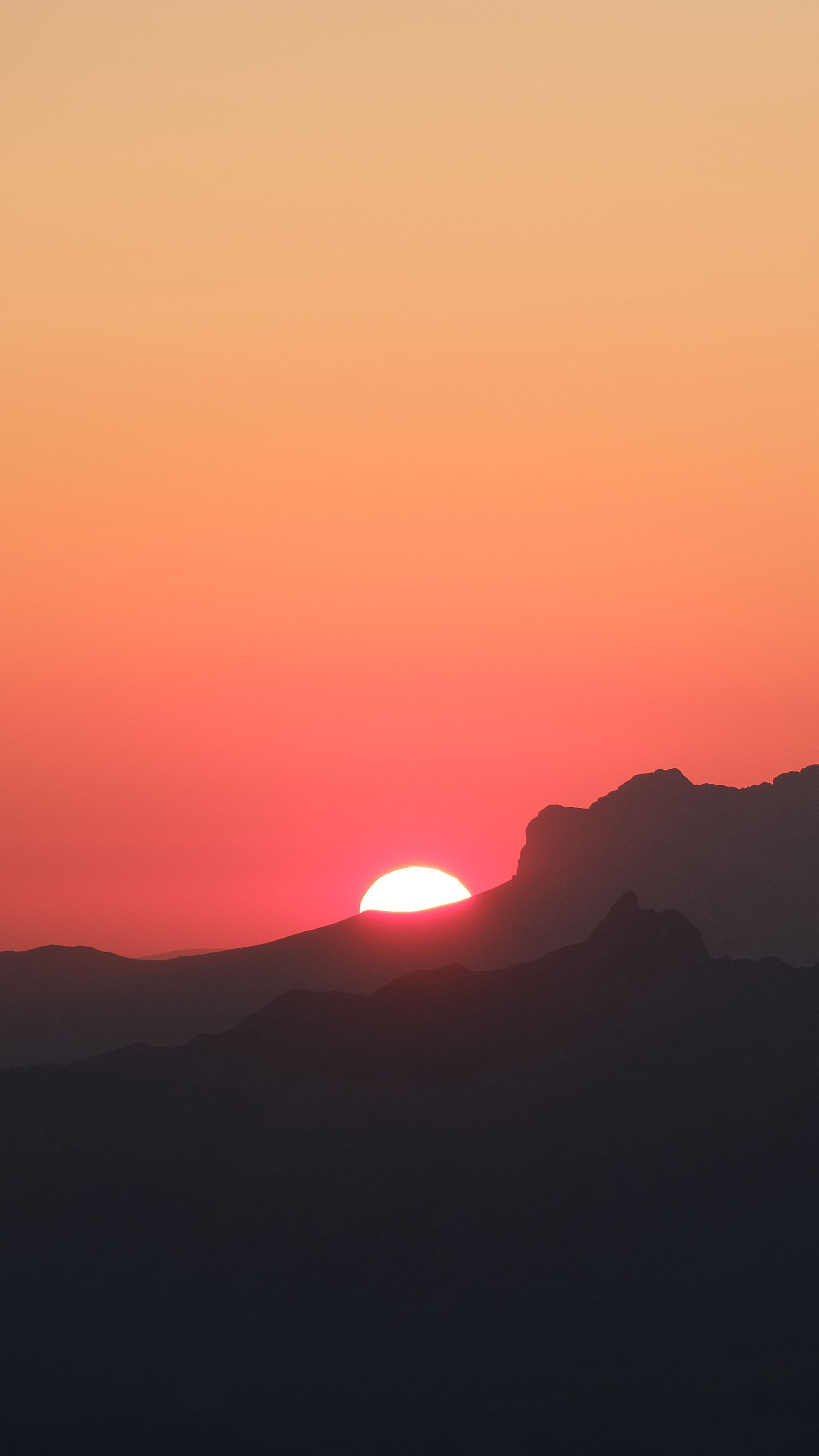 Download wallpaper 2160x3840 mountains, hills, silhouettes, sunset, sun