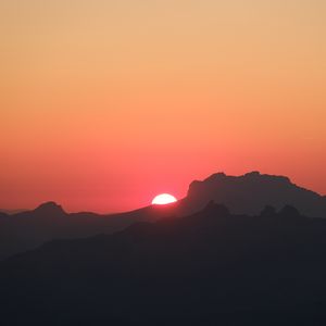 Preview wallpaper mountains, hills, silhouettes, sunset, sun, dark
