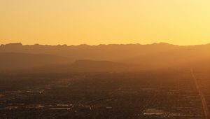 Preview wallpaper mountains, hills, town, sunrise