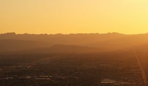 Preview wallpaper mountains, hills, town, sunrise