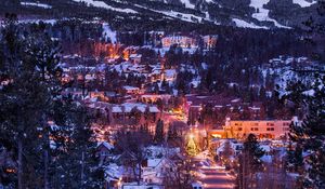 Preview wallpaper mountains, houses, lights, snow, winter, aerial view