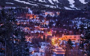 Preview wallpaper mountains, houses, lights, snow, winter, aerial view