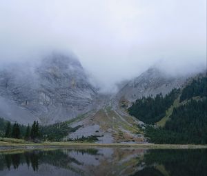 Preview wallpaper mountains, lake, fog, stones, trees
