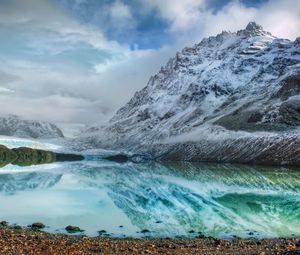 Preview wallpaper mountains, lake, ice, reflection, stones, coast, cold, freshness, clouds