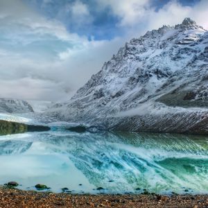 Preview wallpaper mountains, lake, ice, reflection, stones, coast, cold, freshness, clouds